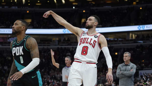 Chicago Bulls guard Zach LaVine (8) watches his three point basket go in as Portland Trail Blazers guard Damian Lillard (0) 